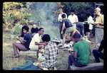 Students and Staff Eating by a Campfire, 1968 by Montclair State College
